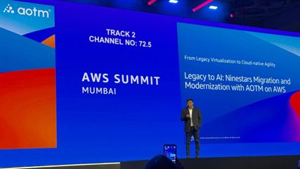 Prashant Akhawat on stage at AWS Summit Mumbai 2025, beside the title slide &lsquo;Legacy to AI: Ninestars Migration and Modernization with AOTM on AWS&rsquo;.