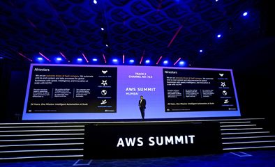 Ninestars &lsquo;outcome-driven AI SaaS&rsquo; overview slide with the AWS Summit Mumbai stage front.