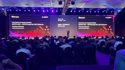 Prashant Akhawat presenting &lsquo;From Patterns to Agentic AI Reality &mdash; AOTM LIFE&rsquo; to a full auditorium at AWS Summit Bengaluru 2026.