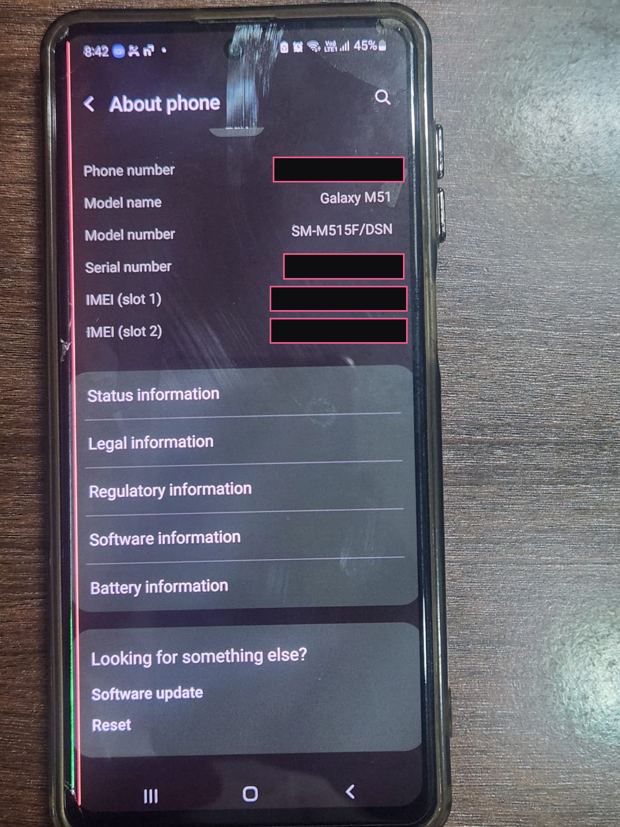 A Galaxy M51 phone on the About phone screen with a pink vertical line running down the left side of the display, personal identifiers blacked out